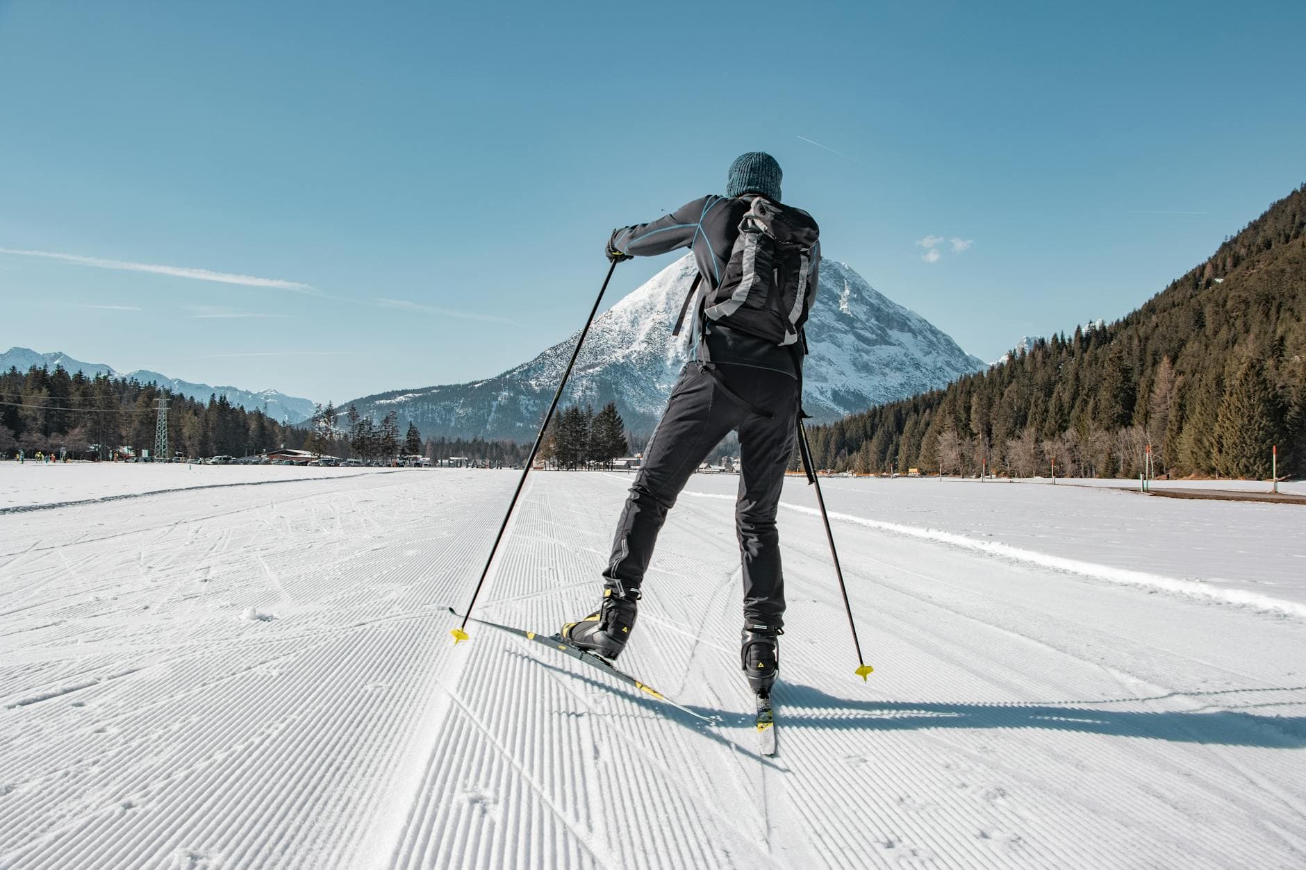 Skier enjoying cross-country skiing in beautiful Tirol, Austria, framed by snowy mountains.