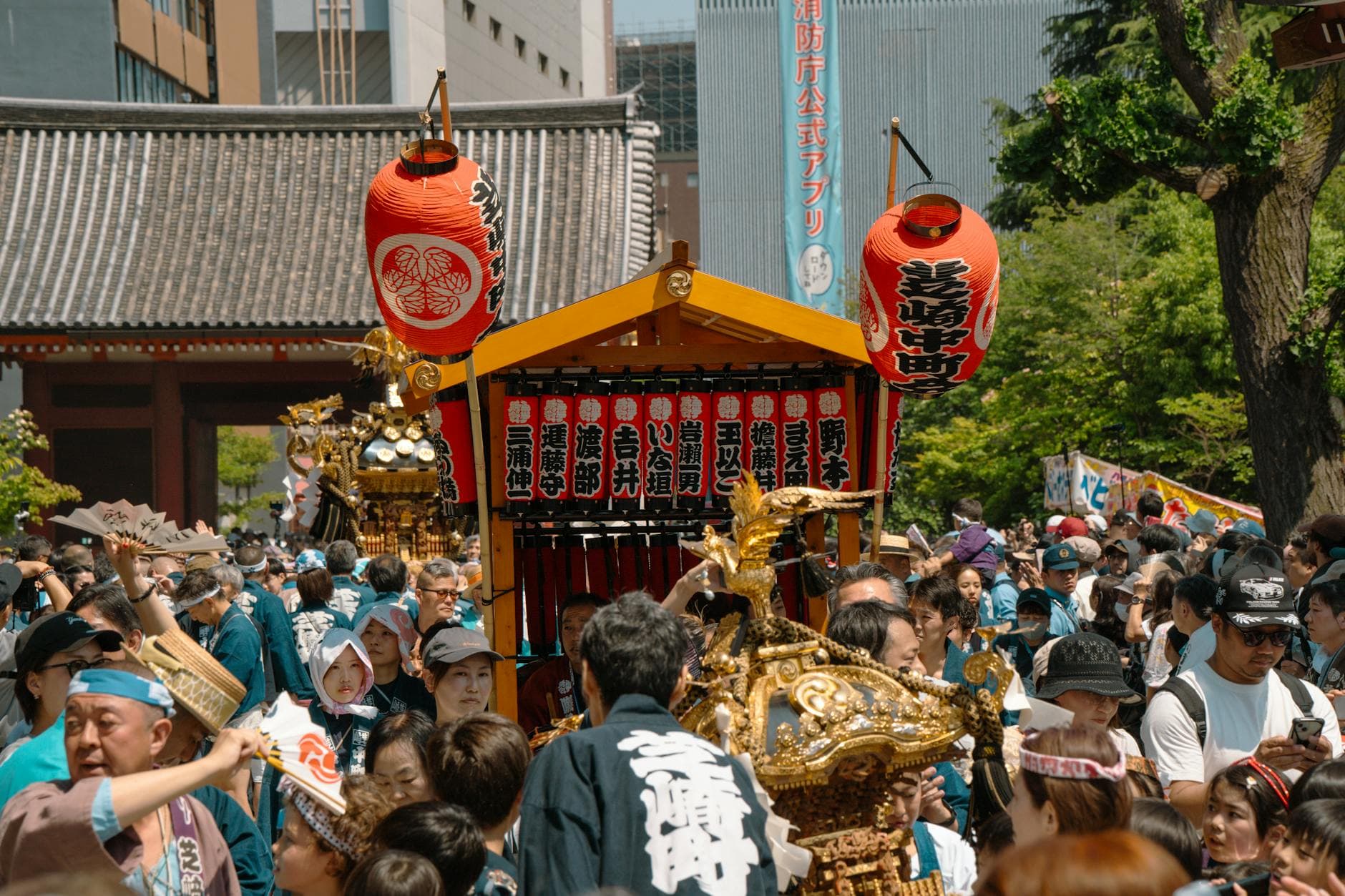 Vibrant festival scene in Tokyo with traditional mikoshi and crowd celebration.