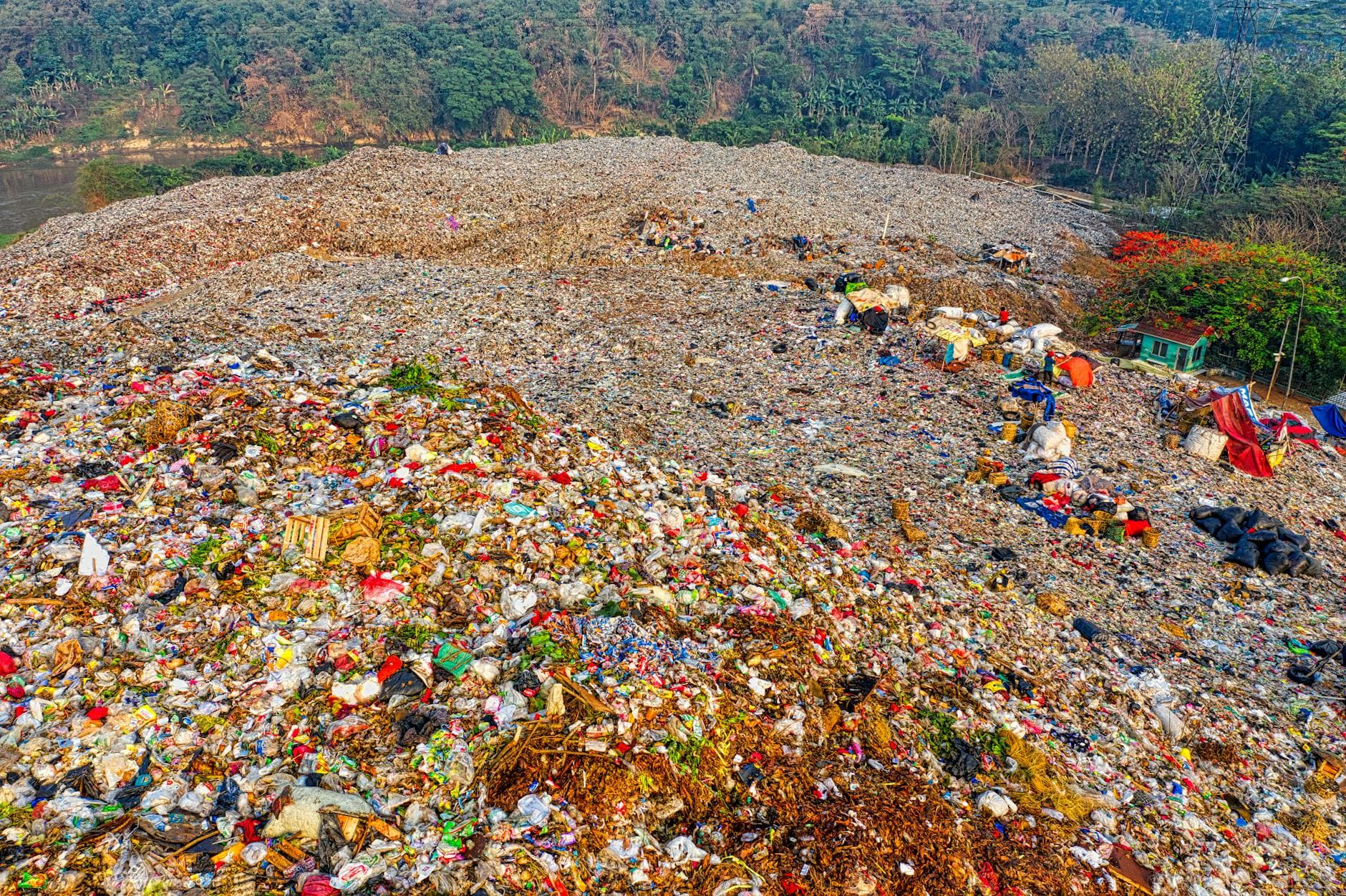 A high-angle view of a vast landfill site in South Tangerang, Indonesia, showing environmental impact.